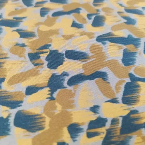 Tessuto raso di seta pura a fantasia gocce colore oro